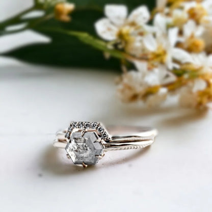 Salt and Pepper Diamond Bridal Ring Set Regal Design featuring a hexagon-cut salt-and-pepper diamond engagement ring set with grey-toned round side stones, straight shank design, and a delicate minimalist band structure in a handcrafted bridal style.