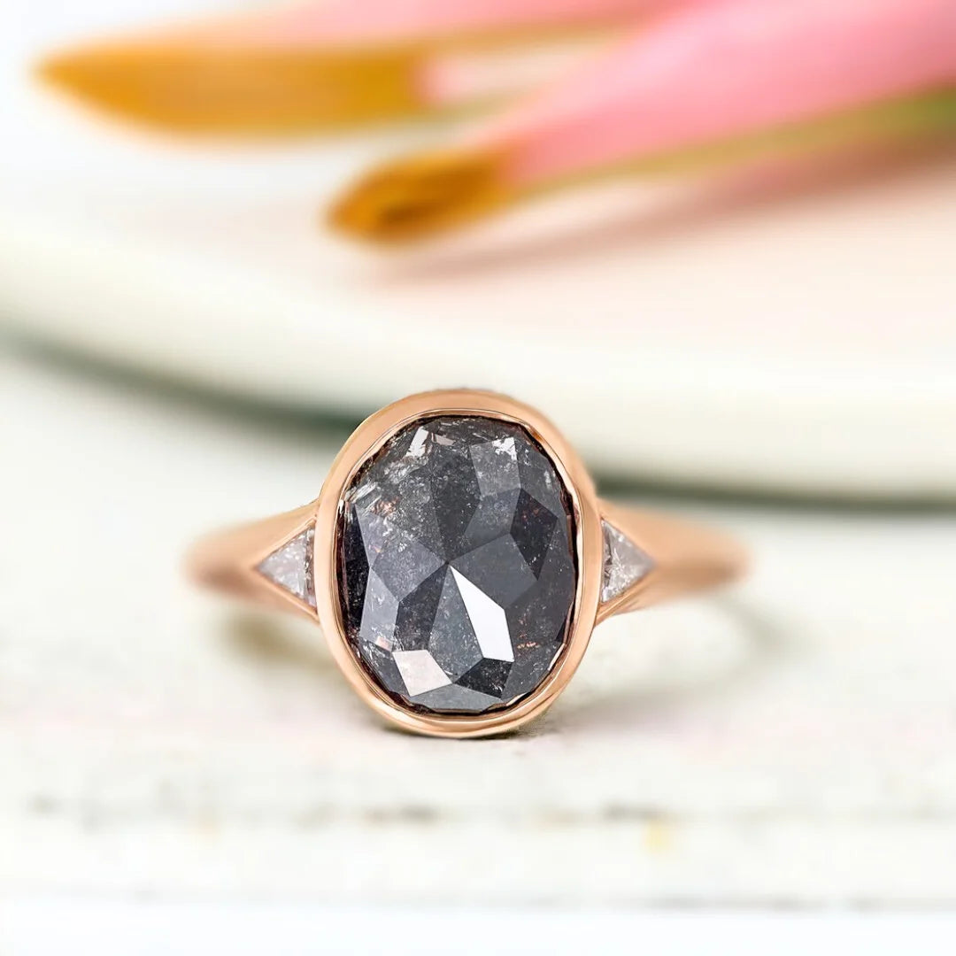 Salt and Pepper Diamond Engagement Ring featuring a rose cushion-cut 2.32 CT diamond with organic inclusions, grey triangle side stones, and a split shank design in a modern engagement ring style.