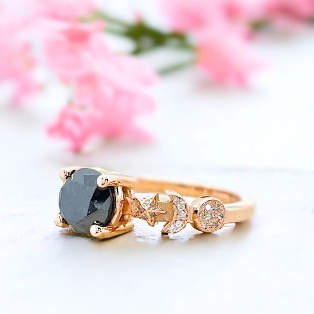 Salt and Pepper Diamond Ring Black Celestial Sun Moon Star Design featuring a round-cut salt-and-pepper diamond centre stone with galaxy-inspired inclusions, accented by round side diamonds in a celestial sun moon star themed ring design with a straight shank and fine band detailing