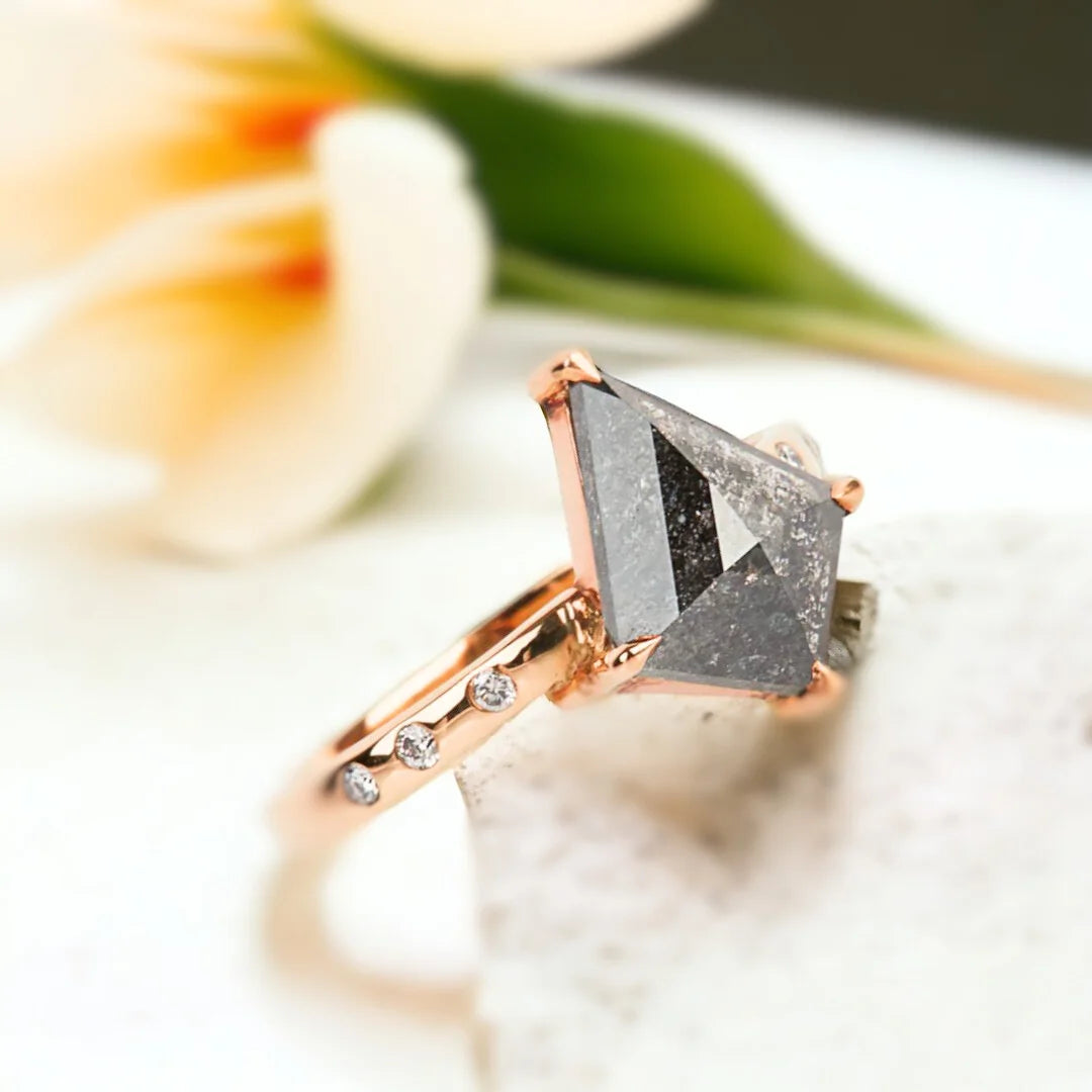 Salt and Pepper Kite Diamond Engagement Ring with 3.10 CT Diamond featuring a kite-cut salt-and-pepper diamond center stone with round side diamonds, side-stone engagement ring design, straight shank band, and a contemporary geometric style.