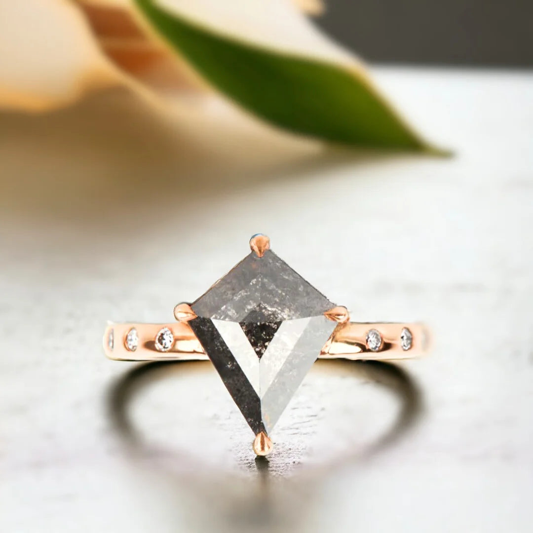 Salt and Pepper Kite Diamond Engagement Ring with 3.10 CT Diamond featuring a kite-cut salt-and-pepper diamond center stone with round side diamonds, side-stone engagement ring design, straight shank band, and a contemporary geometric style.