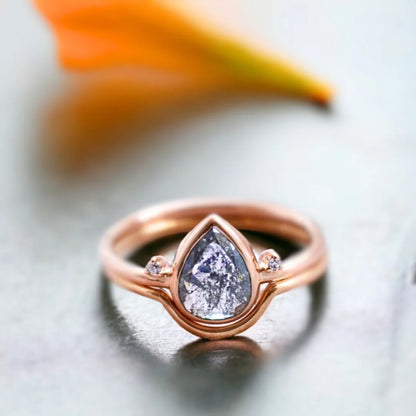 Salt And Pepper Pear Diamond Engagement Ring With Side Stones featuring a 0.94 CT rose pear cut natural salt and pepper diamond with round side diamonds in a vintage inspired minimalist side stone engagement ring design.