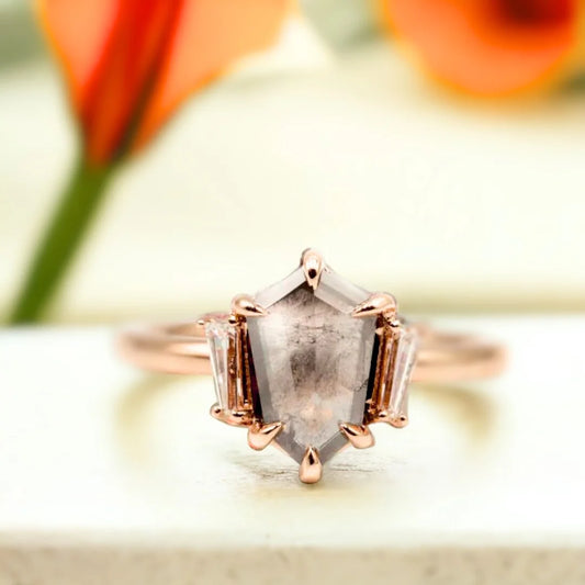 Shield Salt and Pepper Diamond Ring with 1.10 CT shield-cut stone featuring a shield-cut salt and pepper diamond with natural inclusions, baguette side diamonds, a minimalist geometric setting, and a straight shank band in a contemporary engagement ring design.