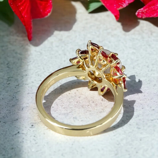 Snowflake Salt and Pepper Diamond Ruby Ring Floral Design featuring a large round-cut salt-and-pepper diamond surrounded by pear-shaped pink ruby petals in a floral engagement ring design with a refined straight shank.