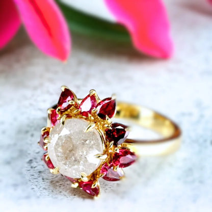 Snowflake Salt and Pepper Diamond Ruby Ring Floral Design featuring a large round-cut salt-and-pepper diamond surrounded by pear-shaped pink ruby petals in a floral engagement ring design with a refined straight shank.
