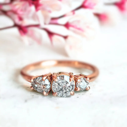 Vintage Trilogy Salt and Pepper Diamond Ring With Round Cut Trio featuring a round-cut grey-toned salt-and-pepper diamond in a trilogy setting with round and pear-cut side stones, vintage-inspired fine diamond ring with a straight shank design and handcrafted detailing.