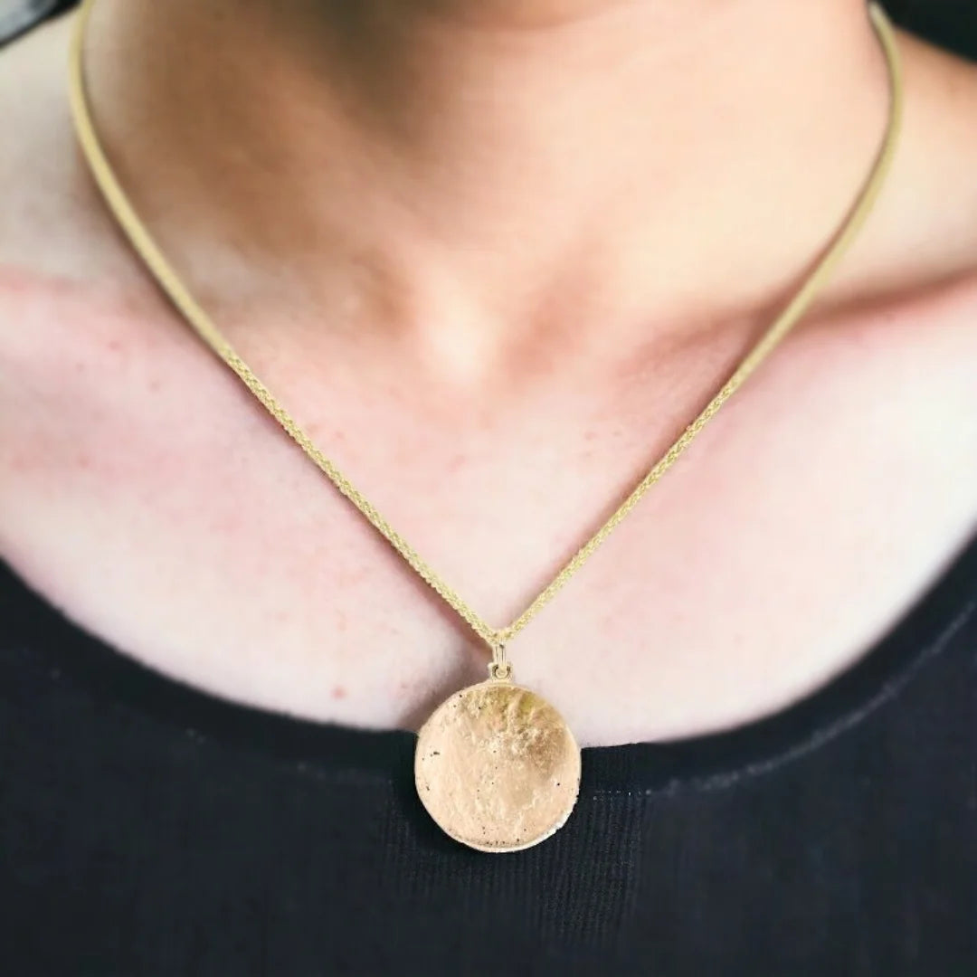 Yellow Gold Molten Disc Pendant Statement Necklace featuring a handcrafted molten disc pendant with a textured surface in a yellow gold tone, paired with an 18-inch cable chain and lobster claw clasp in a minimalist statement necklace design with modern, elegant styling.