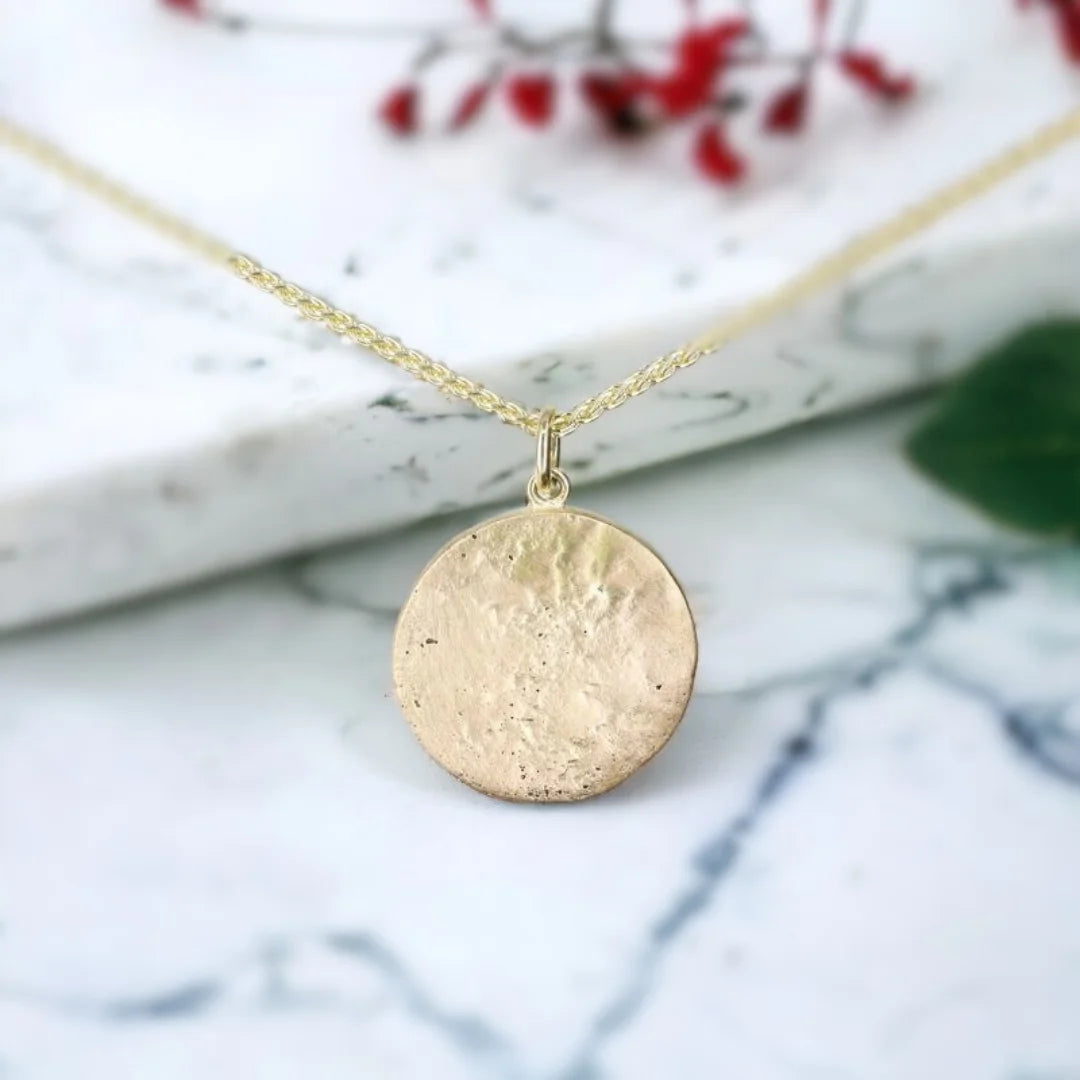 Yellow Gold Molten Disc Pendant Statement Necklace featuring a handcrafted molten disc pendant with a textured surface in a yellow gold tone, paired with an 18-inch cable chain and lobster claw clasp in a minimalist statement necklace design with modern, elegant styling.