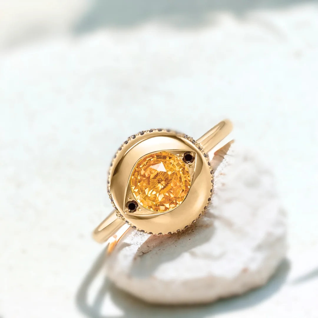 Yellow Sapphire Jubilee Ring with Black Accents and Artisan Design featuring a round Jubilee-cut yellow sapphire, black accent stones, gold ring setting, straight shank band, and handcrafted artisan styling.