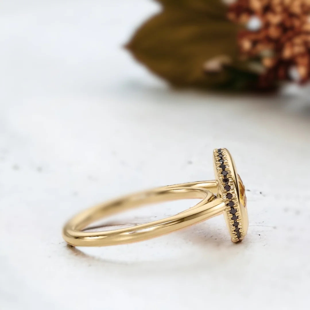Yellow Sapphire Jubilee Ring with Black Accents and Artisan Design featuring a round Jubilee-cut yellow sapphire, black accent stones, gold ring setting, straight shank band, and handcrafted artisan styling.